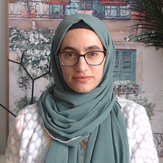 A photo of Samar, wearing a blue hijab and a white shirt