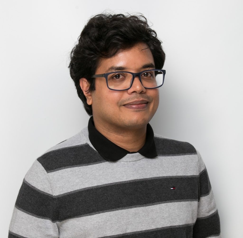 A picture of Rifat, wearing a striped long sleeve shirt