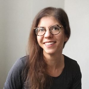 a picture of Reese Muntean, wearing a black shirt and glasses