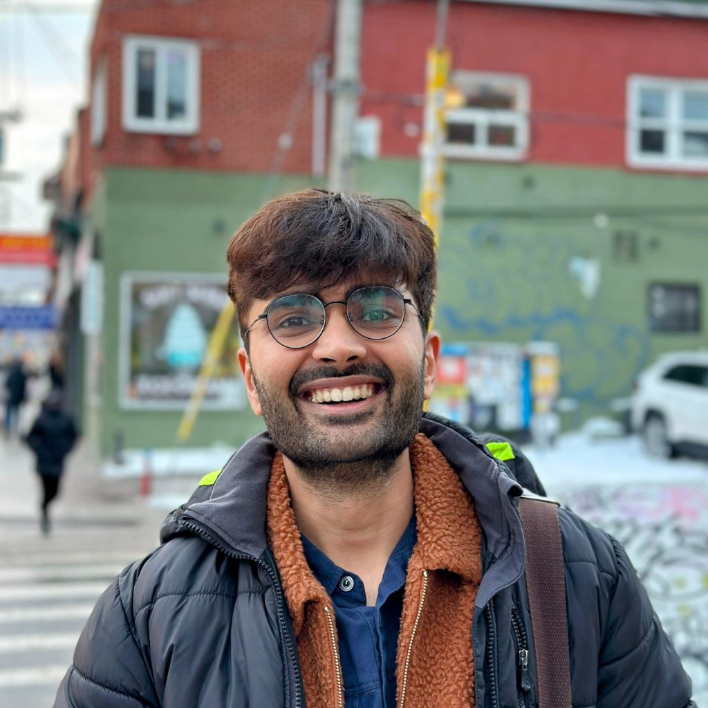 A photo of Harshit Gujral wearing a jacket outside